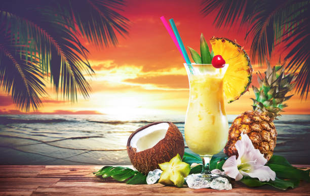 Pina colada fresh cocktail drink served on the beach at sunset Pina colada fresh cocktail drink served with pineapple and coconut on the beach at sunset tropical drink stock pictures, royalty-free photos & images