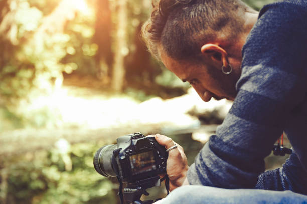 istock Man taking photo in wood 984130686