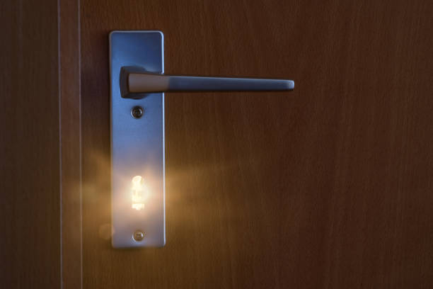 istock Light trough a key hole of a door 984134798
