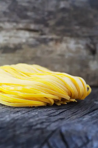 Cooking background. Fresh egg homemade pasta on wood