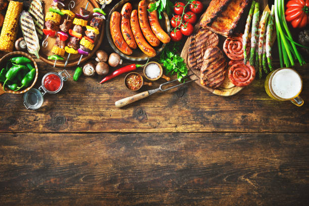istock Grilled meat and vegetables on rustic wooden table 984139092