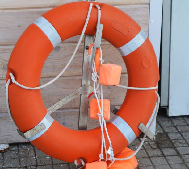 istock Old lifebuoy on the beach, rescue symbol, help 984140594