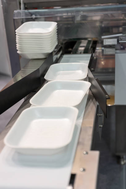 istock Plastic food trays on the conveyor of the packaging machine 984156514
