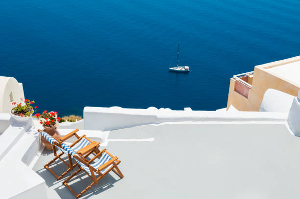 istock Two chaise lounges on the terrace with sea view 984174350