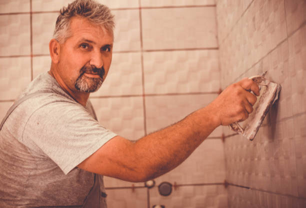 istock Handyman laying ceramic tiles. 984187234
