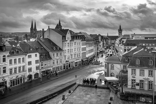 TRIER, GERMANY - FEBRUARY 21, 2017: Black and white view into Simeonstrasse mall of the Medieval town of Trier
