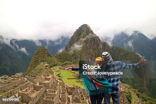 istock Couple admiring the spectacular view of Machu Picchu, Cusco Region, Urubamba Province, Peru, Archaeological site, UNESCO World Heritage 984199180