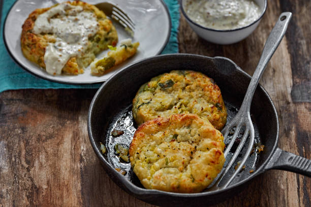 istock Haddock cabbage potato cakes with mustard sauce on wooden table 984228776