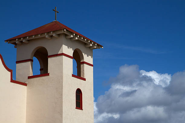 Entrance to the San Geronimo de Taos Catholic Chapel. The brown and white stucco is accented by the bright blue New Mexico sky. The church has with stood time as to mirror the strength of the Puebloan people adapting to the cultural changes over generations.
