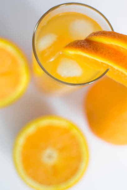 istock Fresh, cold orange juice with oranges placed on the white board 984250976