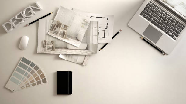 istock Architect designer concept, white work desk with computer, paper draft, bedroom project images and blueprint. Sample color material palette, creative background idea with copy space 984254458