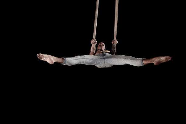 istock Single straps. Scenic circus arts in studio photography with a man 984254896