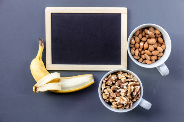 istock cups full of almonds and walnuts with banana 984254964