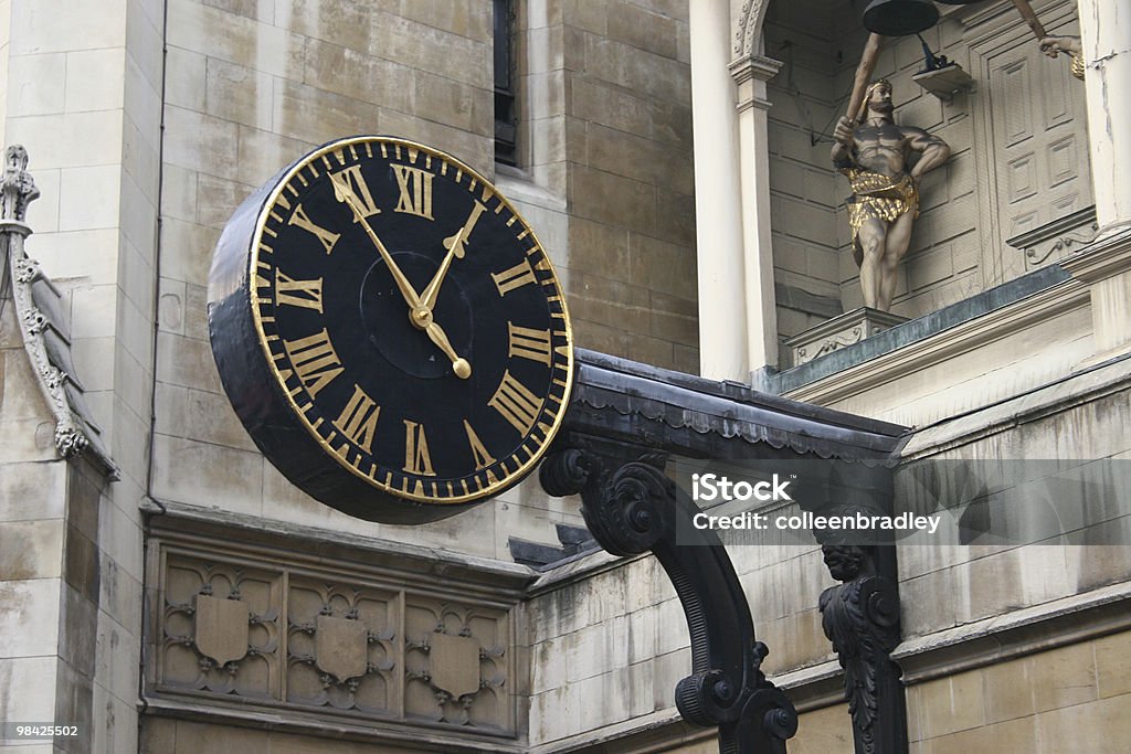 Clock in London Clock in business district at lunch time in London Building Exterior Stock Photo