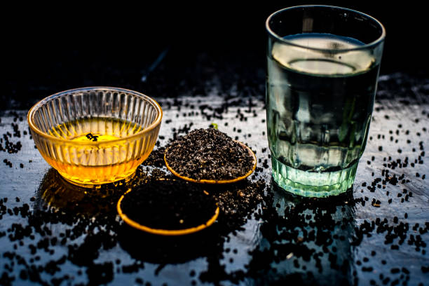 close up of kalonji or roman coriander with water and honey on wooden surface beneficial for diabetes patient, good in losing weight. - ingredient fennel food dry imagens e fotografias de stock