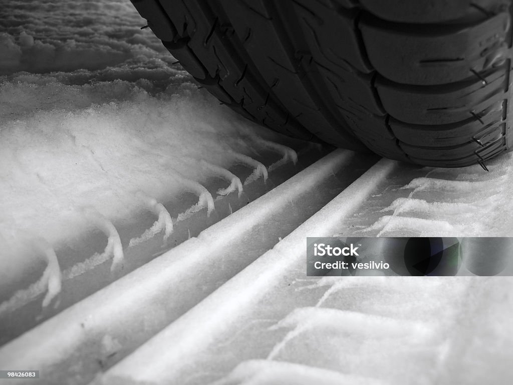 Winter grip Car tyre trace on snow surface. Black And White Stock Photo