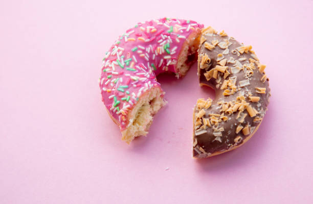 istock Two parts of donuts, pink and chocolate 984264618