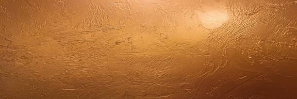 istock Gold background or texture and gradients shadow. Shiny yellow leaf gold foil texture background. Gold background paper, texture is old vintage distressed solid glitter gold color with rough peeling grunge paint on edges. 984272498