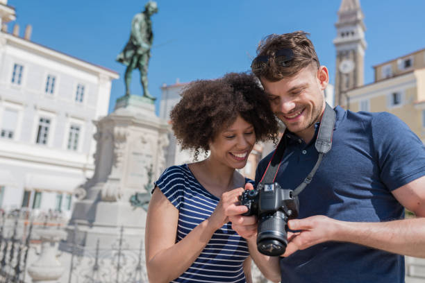 istock Young Couple Looking Photos On Camera 984272978