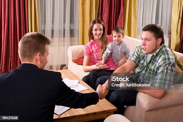 Happy Family Meeting With Agent At Home Stock Photo - Download Image Now - Adult, Advice, Agreement