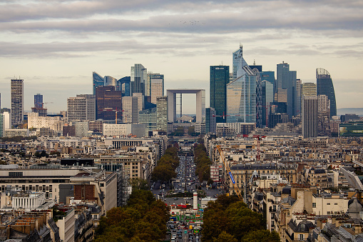Paris, France - October 28, 2017: La Defense Financial District in Paris in autumn. Heavy traffic on Champs-Elysees. Modern vs. old architecture.