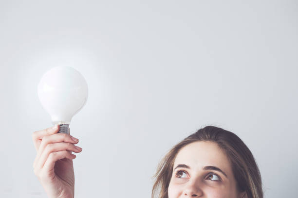 istock Woman holding a light bulb 984277740