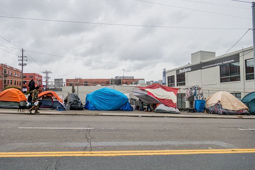 Homeless tents line city streets in San Francisco. \nHomeless community creates a camp with all their suitcases, tents, sleeping bags and precious belongings.