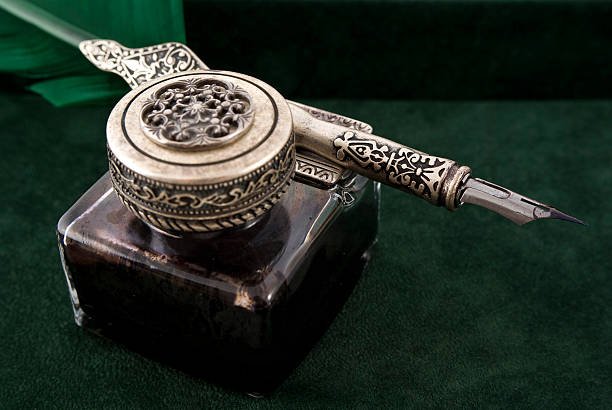 Close-up of an ink pot and quill.