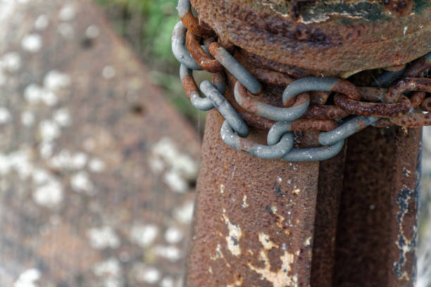 istock Rusty steel chain element, industrial background for commercial use 984281790