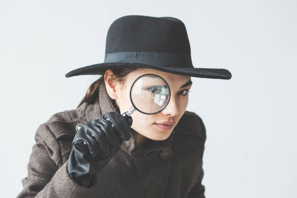 Woman with the magnifying glass Woman with the magnifying glass detective stock pictures, royalty-free photos & images