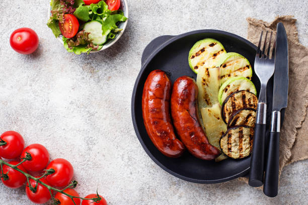 istock Grilled pork sausages and vegetables 984285982