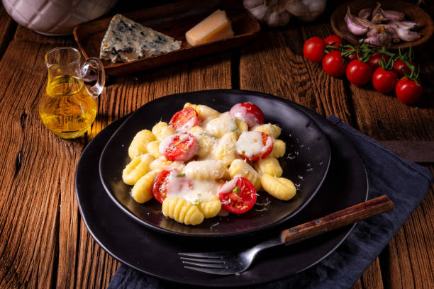 istock gnocchi baked with green pesto, cherry tomatoes and parmesan 984302194