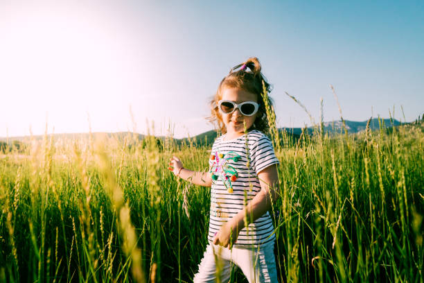 istock Little girl playing in wheat field 984312530