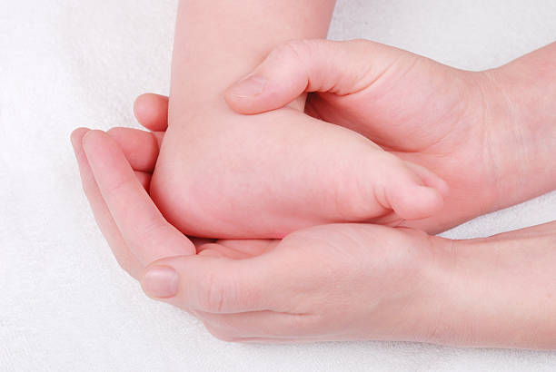 istock Baby feet in mommy's hands 98431554