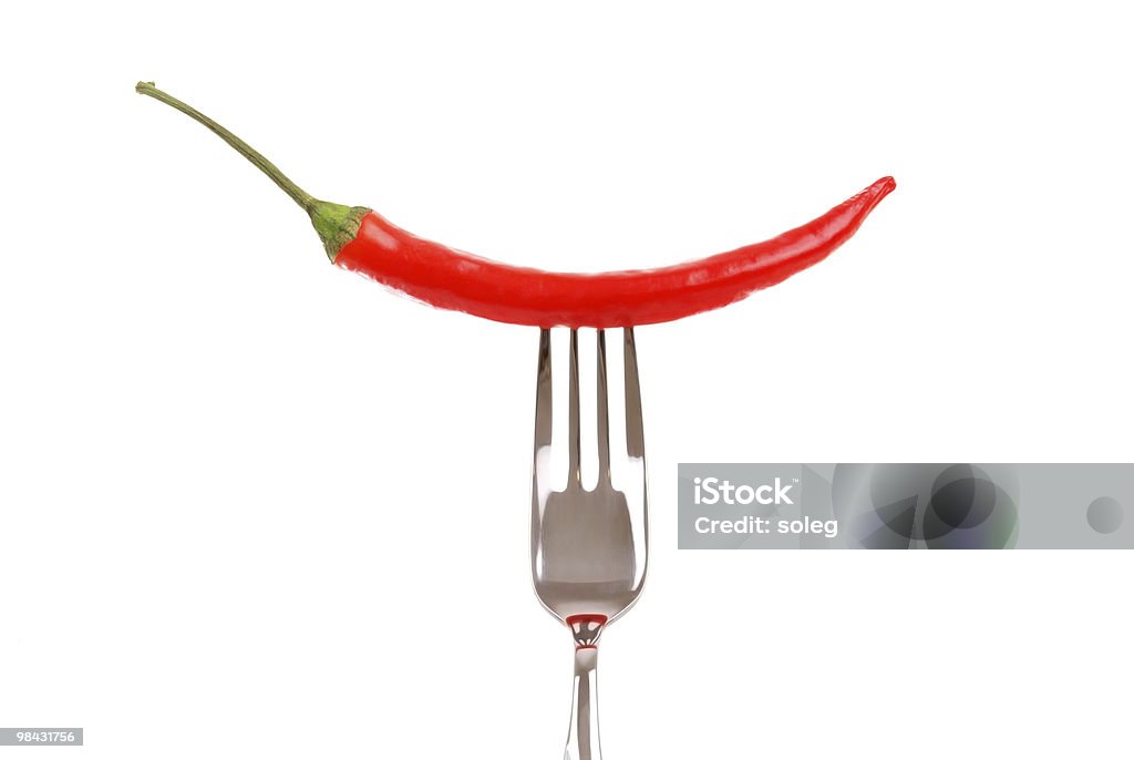 Red hot chili pepper pricked on the steel fork  Chili Pepper Stock Photo