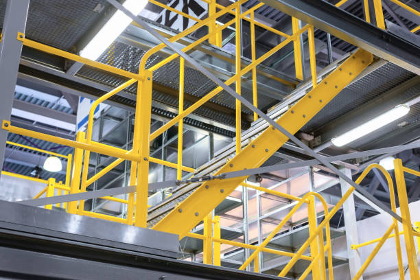 istock Metal staircase, with yellow railings and metal steps 984335286