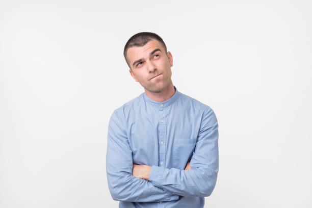 istock Let me think or oubt concept. Young hispanic man is very serious and pensive 984335798