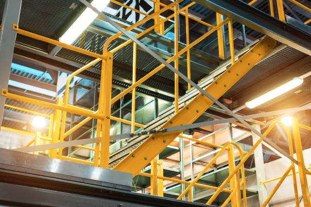 istock Metal staircase, with yellow railings and metal steps 984336014