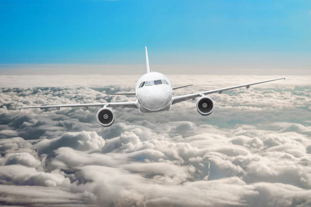 istock Airplane in the sky above the clouds flight journey sun height 984342146