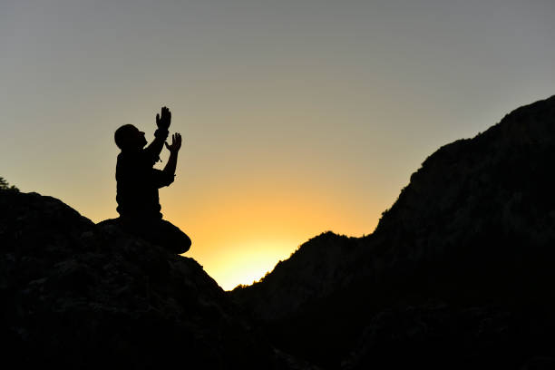 istock supplication, prayer, meditation ;lift your hands towards the sky 984347904