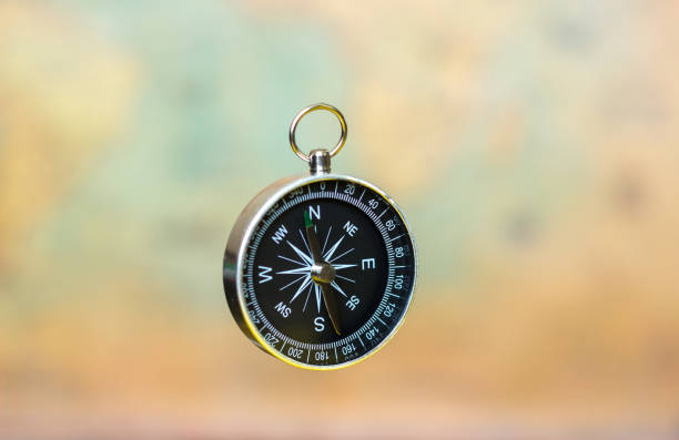 istock compass on a blurry background with a vintage world map 984348454