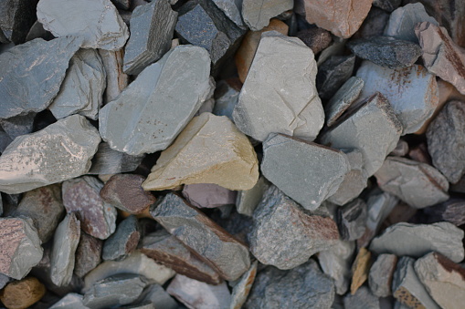 Brilliant pebbles and small stones  in bright colors for garden decoration in sunny  summer time .
