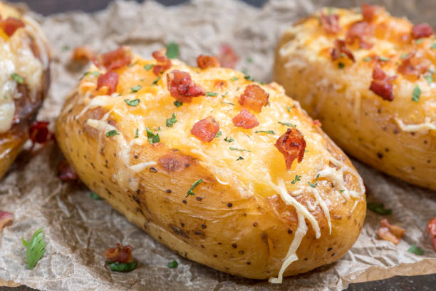 istock Baked loaded potato with bacon, cheese and onion 984397392