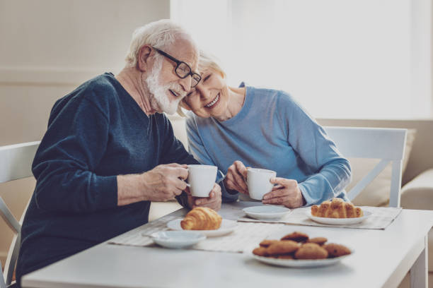 istock Happy joyful couple having a meal 984413438