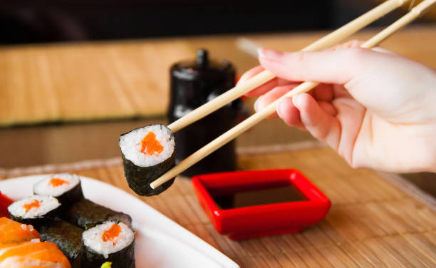 istock sushi keep chopsticks and dipped into the sauce 984427768