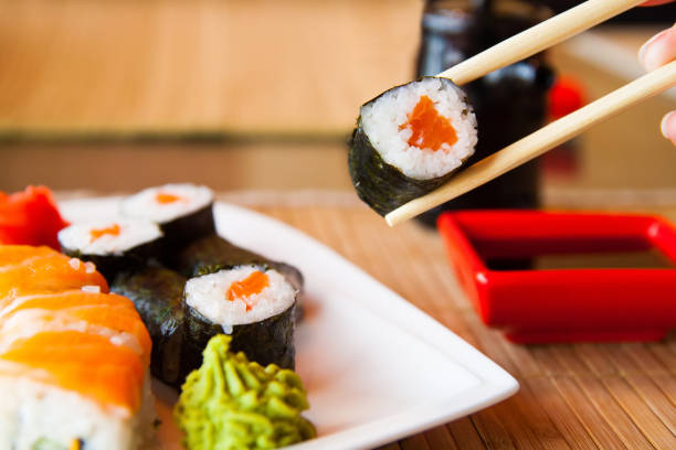 istock sushi keep chopsticks and dipped into the sauce 984427778