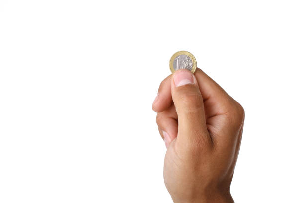 man's hand holding euro coin