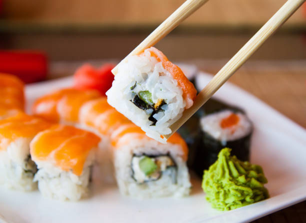 istock sushi keep chopsticks and dipped into the sauce 984427890