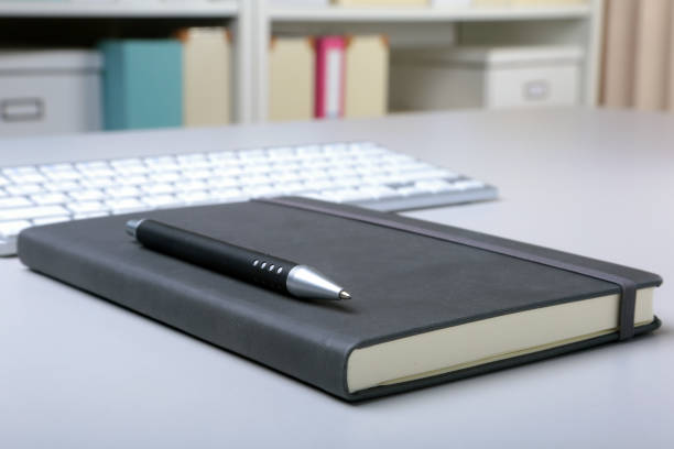 istock Business accessories on desktop: notebook, diary, fountain pen, glasses. Macro with blur and soft focus. 984439298