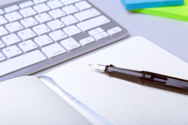 istock Business accessories on desktop: notebook, diary, fountain pen, glasses. Macro with blur and soft focus. 984439510